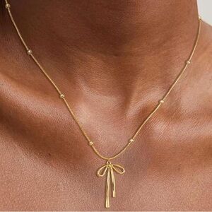 14k gold mini bow necklace 16-18 inches adjustable chain with lobster closure